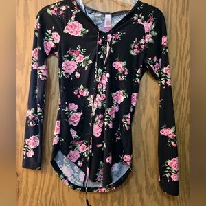 Pretty, long sleeve black blouse with pink flowers, lace-up neck and hood.